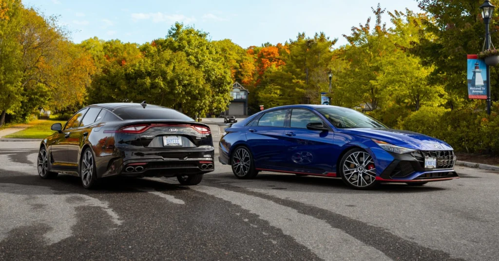 A Kia Stinger and a Hyundai Elantra N parked side by side